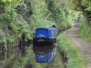 Narrow boat passing through Pendleford Rockin. Single track canal with passing places